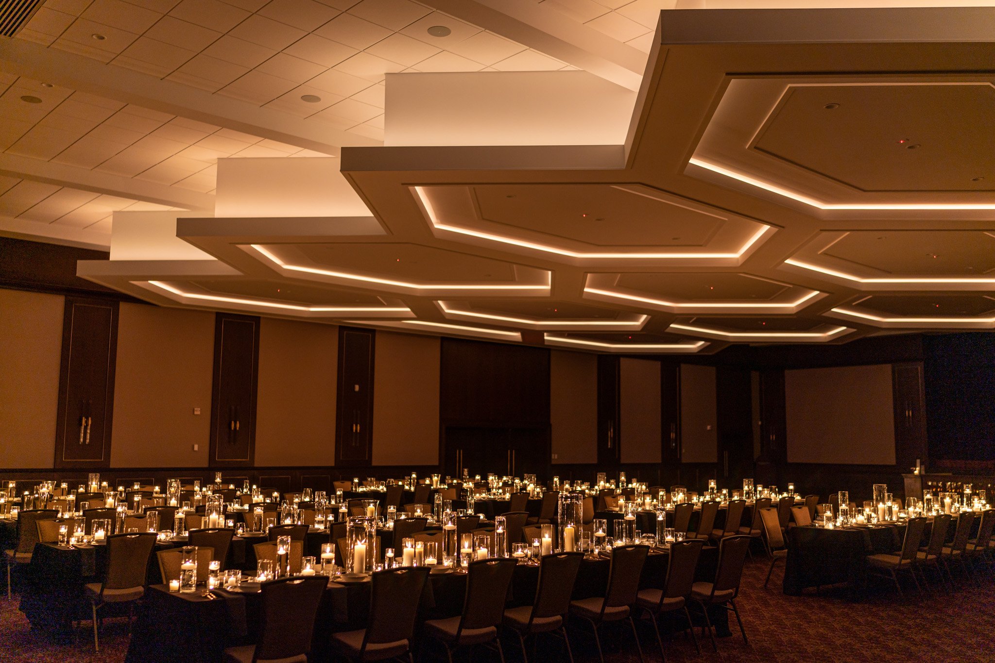 The Grand Ballroom — coffered hexagonal ceiling above candlelit banquet tables