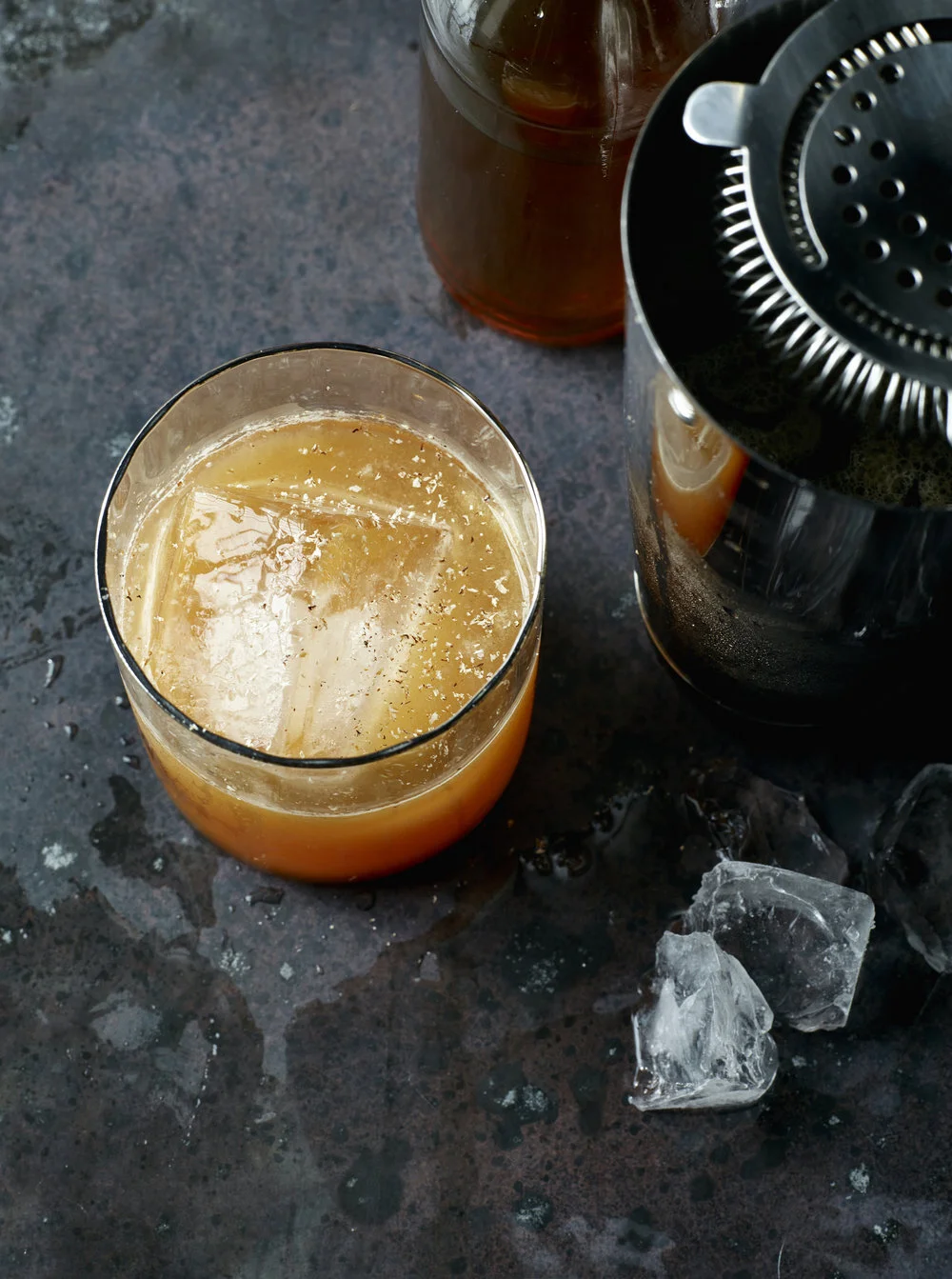 A craft cocktail with smoky bar shaker