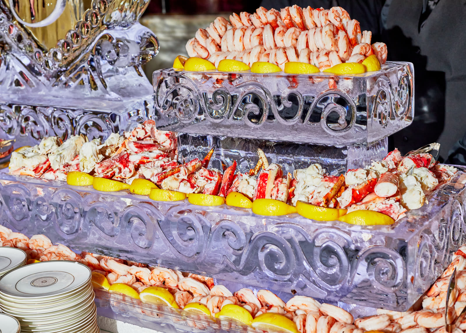 A seafood raw bar of shrimp and crab served on a carved ice display